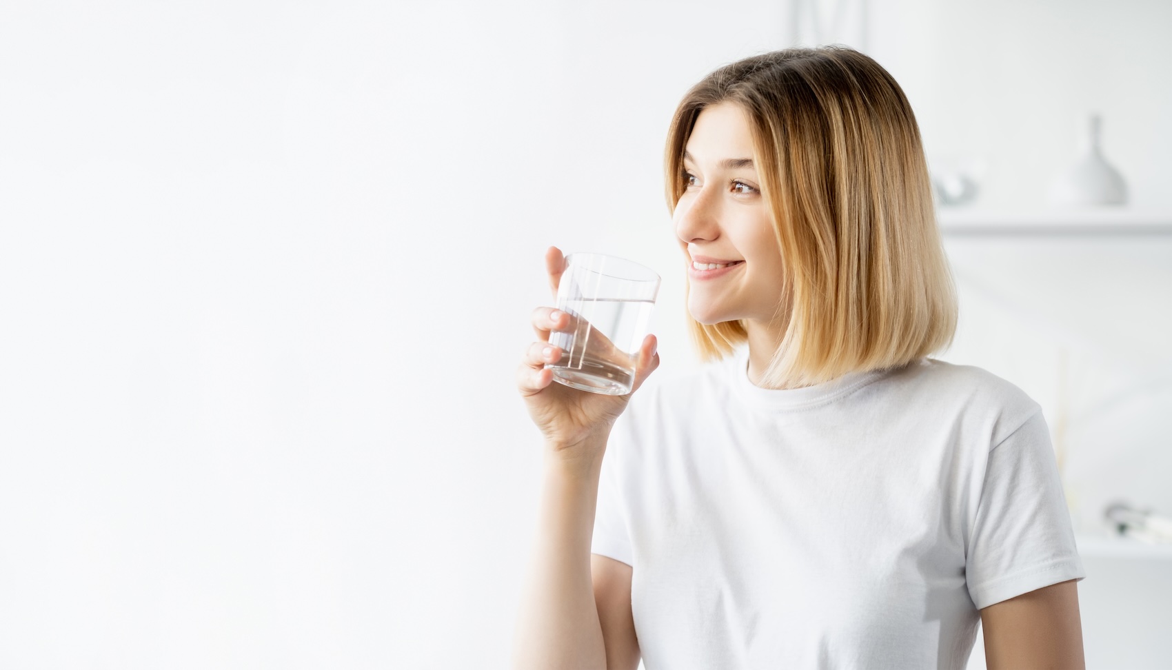 Happy woman drinking water with white background.
