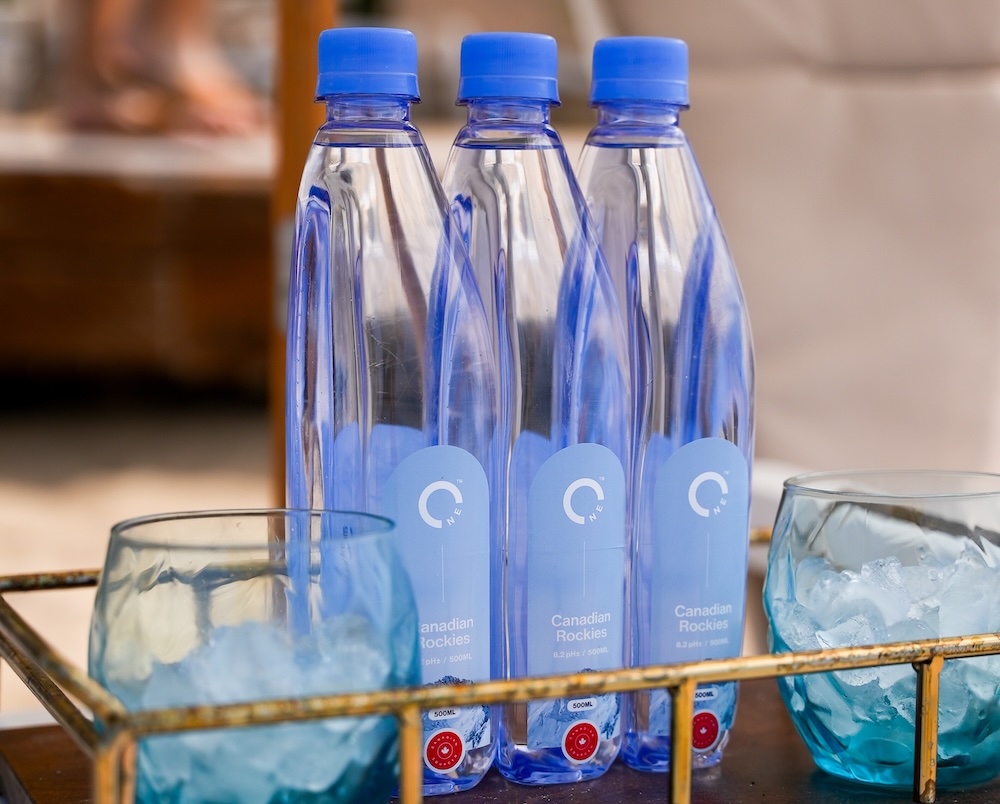 Three interlocked snap-to-stack bottles on a serving tray.