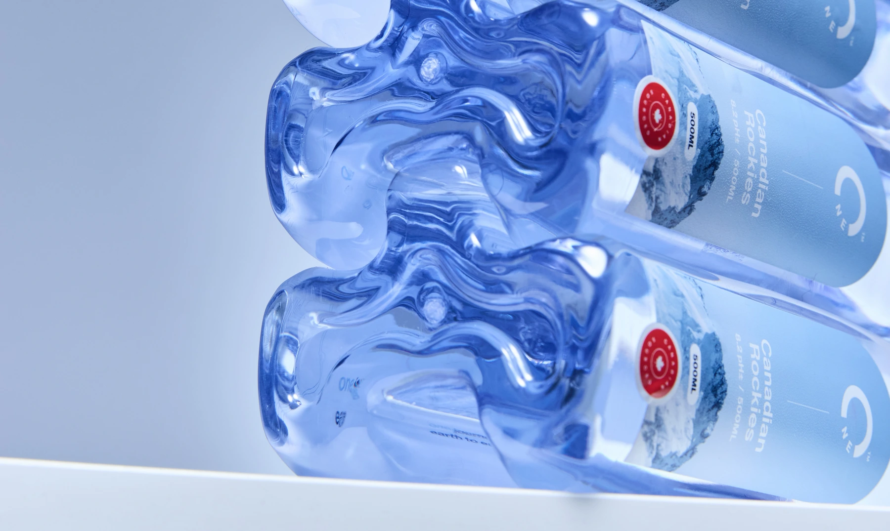 Three stacked One Water bottles from the Canadian Rockies.